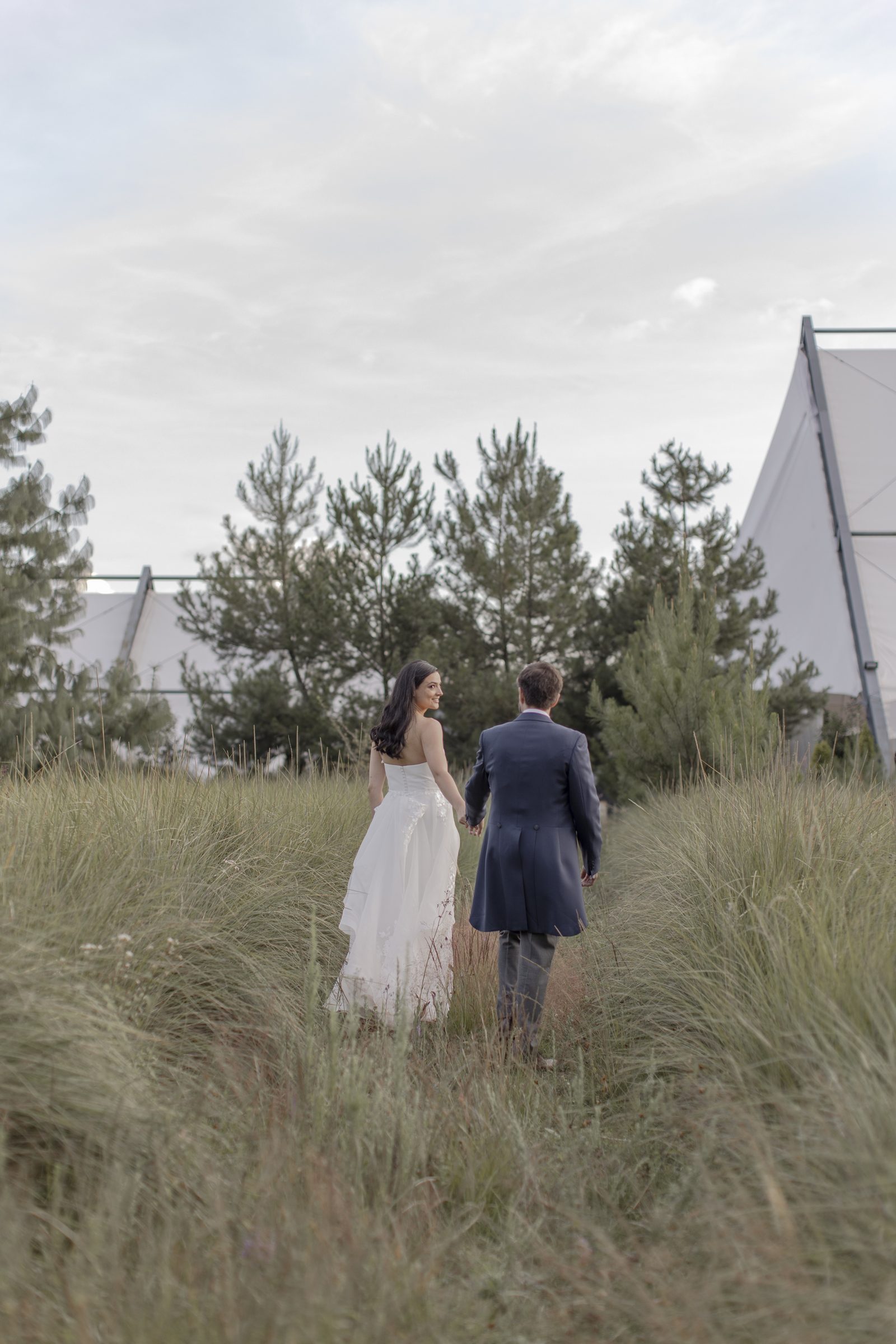 Couple walking through tall grass